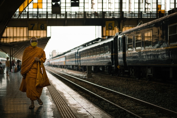 person walking next to a train