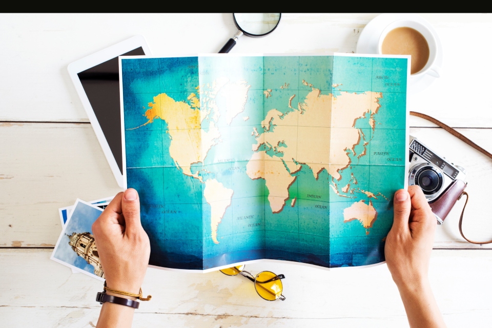 person holding global map